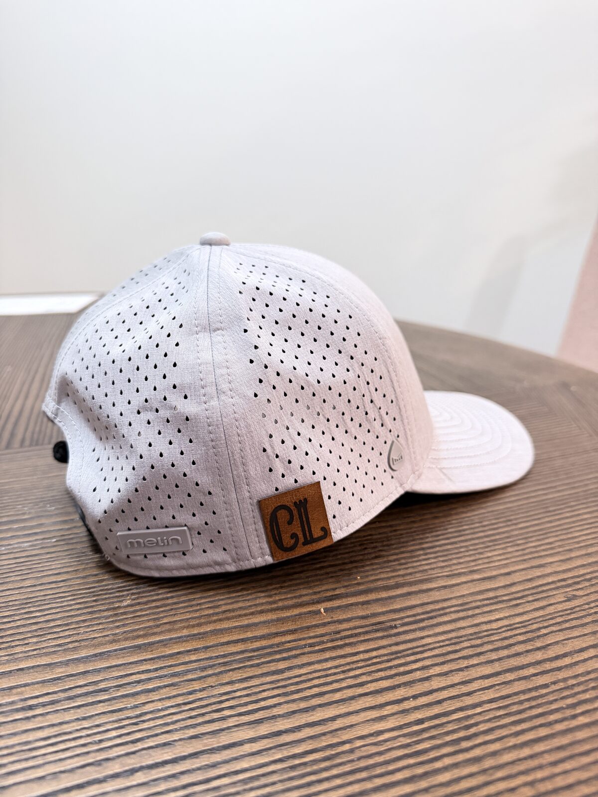 Custom leather patch pressed onto a trucker cap